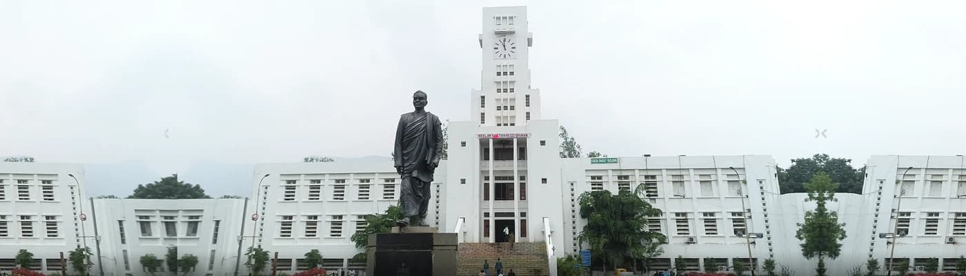 The Sri Venkateswara University administrative building and clock tower, with a statue in the foreground